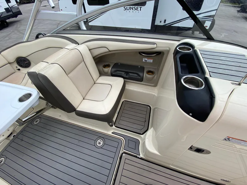 Slide: The Image of Interior of 2014 Yamaha Boats 242 Limited S, featuring beige seating and cup holders. - 16