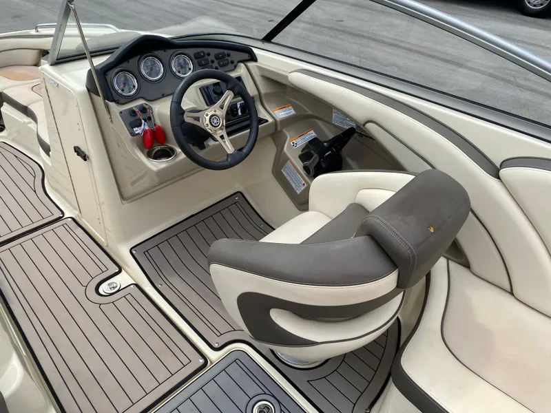 Slide: The Image of 2014 Yamaha Boats 242 Limited S cockpit with steering wheel and seating. - 21