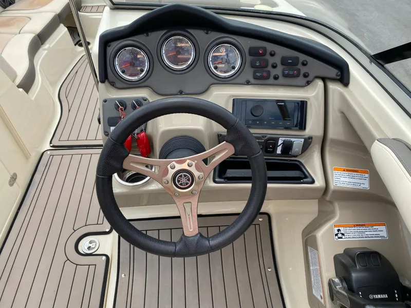 Slide: The Image of 2014 Yamaha Boats 242 Limited S dashboard with steering wheel and control panel. - 22