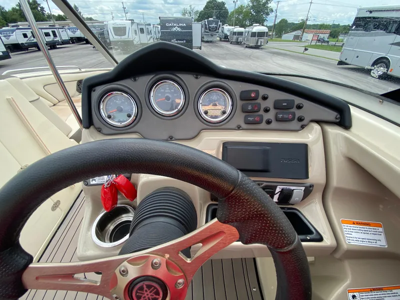 Slide: The Image of 2014 Yamaha Boats 242 Limited S dashboard with steering wheel and gauges. - 26