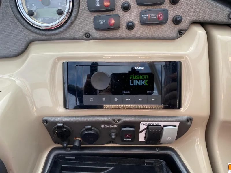 Slide: The Image of 2014 Yamaha Boats 242 Limited S dashboard with Fusion stereo system and controls. - 29