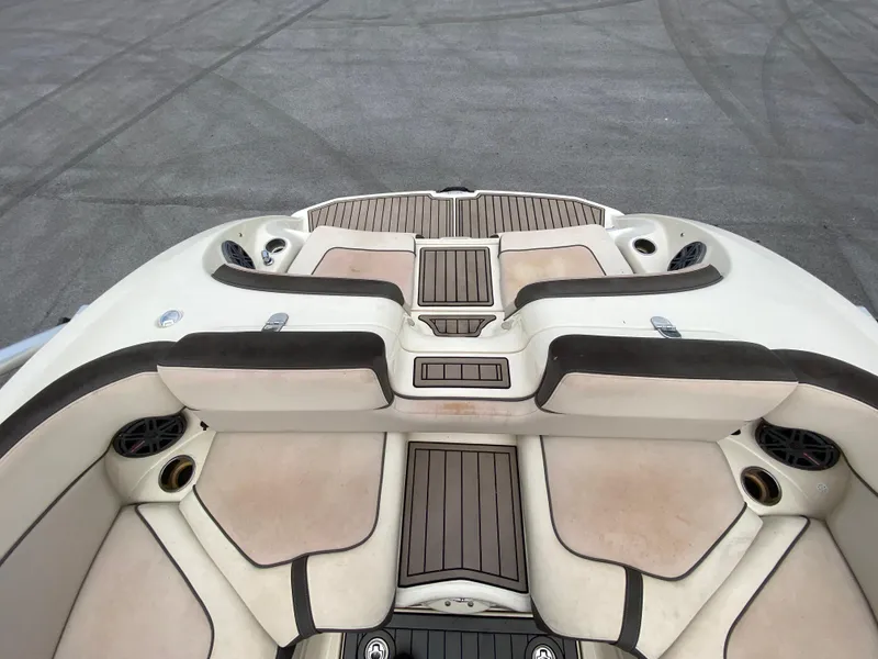 Slide: The Image of 2014 Yamaha Boats 242 Limited S interior with cushioned seating and wood accents. - 32