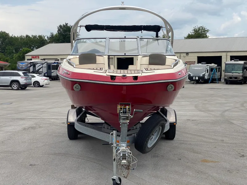 Slide: The Image of 2014 Yamaha Boats 242 Limited S, red, on trailer in parking lot. - 36