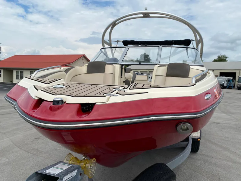 Slide: The Image of 2014 Yamaha Boats 242 Limited S, red and white, on trailer, outdoor setting. - 37