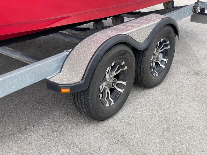 Slide: The Image of Trailer wheels of a 2014 Yamaha Boats 242 Limited S on pavement. - 42