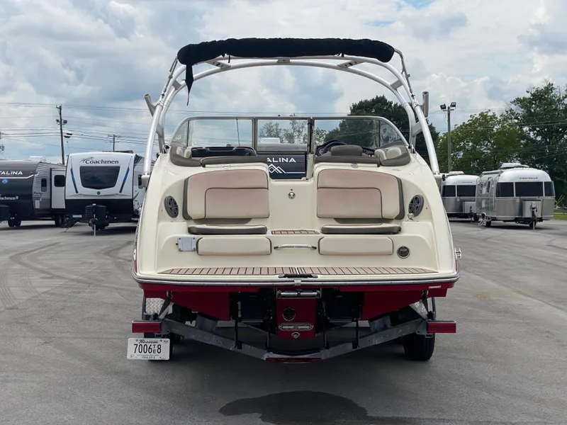 Slide: The Image of 2014 Yamaha Boats 242 Limited S, rear view, parked in a lot with trailers. - 48