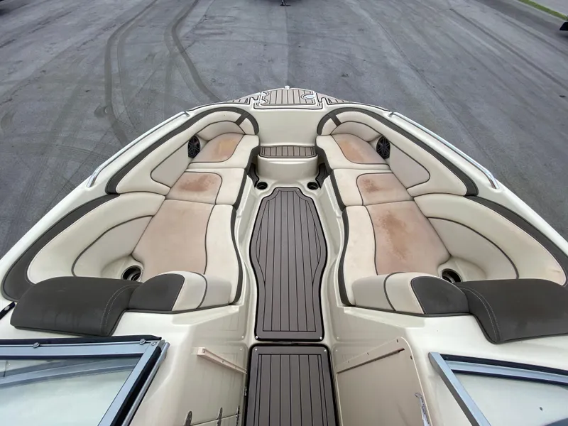 Slide: The Image of 2014 Yamaha Boats 242 Limited S interior with beige seating and wood accents. - 9