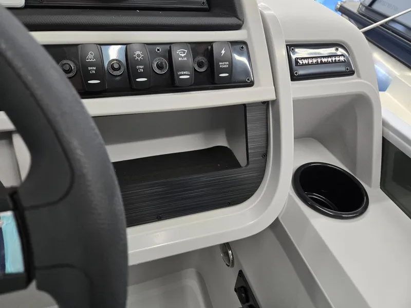 Slide: The Image of Dashboard of 2025 Godfrey Sweetwater 2086 C boat with control panel and cup holder. - 17