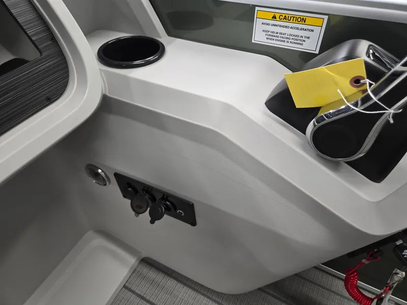 Slide: The Image of Interior of 2025 Godfrey Sweetwater 2086 C boat with control panel and caution sign. - 18