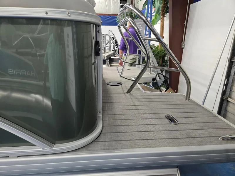 Slide: The Image of 2025 Godfrey Sweetwater 2086 C pontoon boat deck with railing and sleek design. - 2