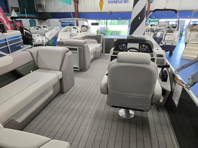 Slide: The Image of 2025 Godfrey Sweetwater 2086 C pontoon boat interior with plush seating and modern helm. - 28