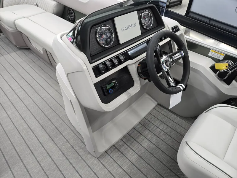 Slide: The Image of 2025 Godfrey Sweetwater 2086 C boat interior with Garmin dashboard and steering wheel. - 32