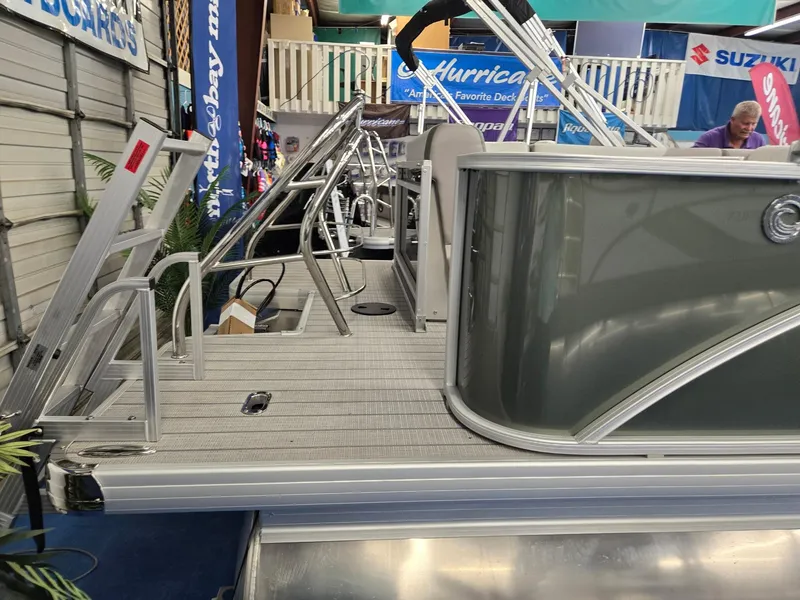 Slide: The Image of 2025 Godfrey Sweetwater 2086 C pontoon boat at a showroom display. - 6