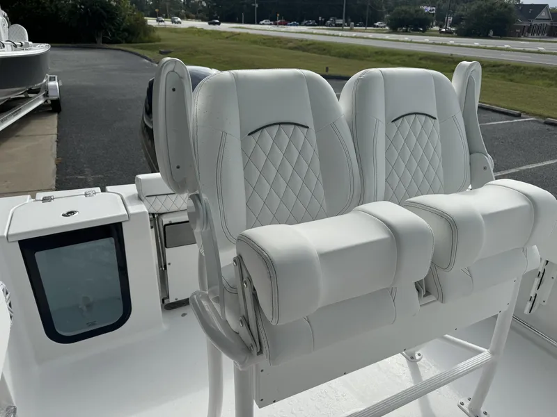 Slide: The Image of 2025 Sportsman Open 212 Center Console boat with white cushioned seats. - 10