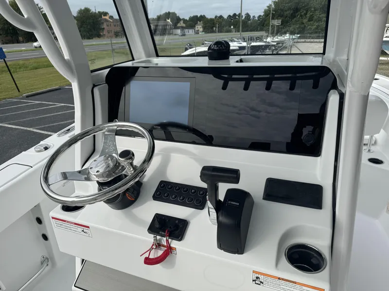 Slide: The Image of 2025 Sportsman Open 212 Center Console dashboard with steering wheel and controls. - 11