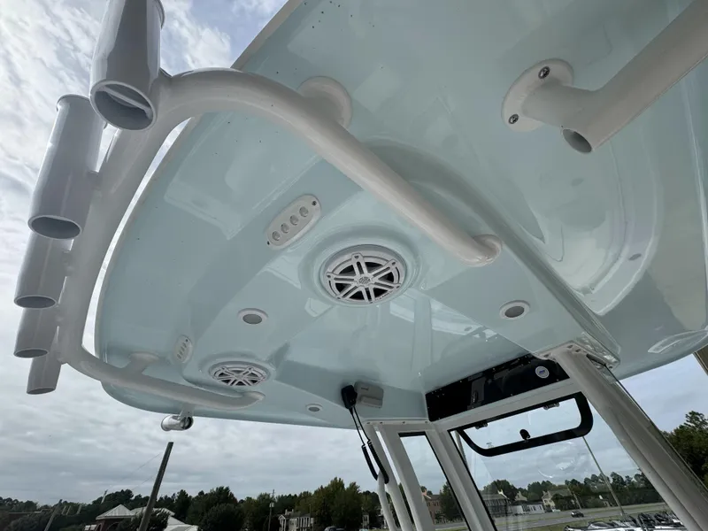 Slide: The Image of 2025 Sportsman Open 212 Center Console boat, featuring overhead speakers and rod holders. - 12
