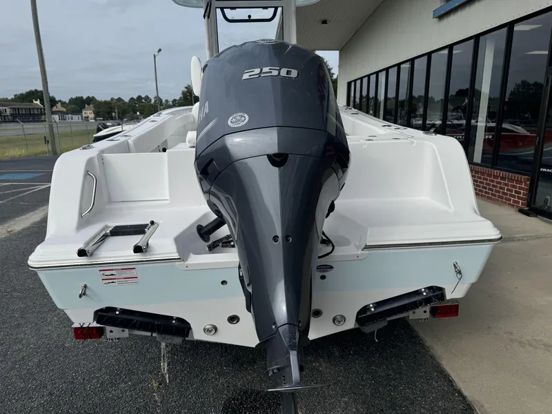Slide: The Image of 2025 Sportsman Open 212 Center Console boat with powerful 250 engine, parked outdoors. - 4