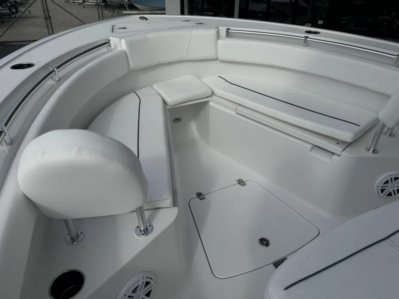 Slide: The Image of 2025 Sportsman Open 212 Center Console boat interior with white seating and storage compartments. - 8