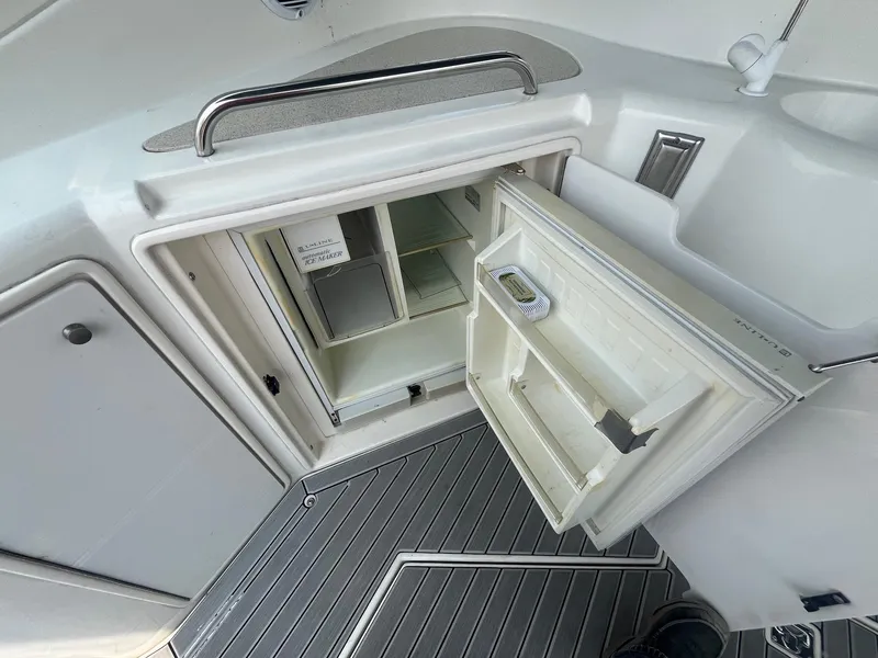 Slide: The Image of 2001 Cruisers Yachts 3870 Express interior with open storage compartment and sleek flooring. - 19