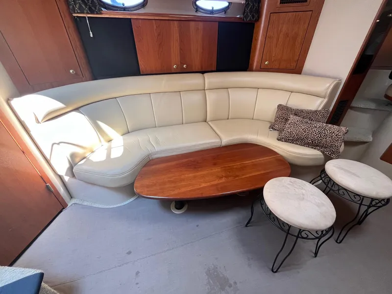 Slide: The Image of 2001 Cruisers Yachts 3870 Express interior with beige leather seating and wooden table. - 23