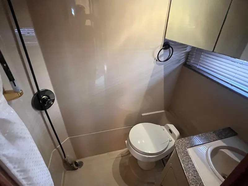 Slide: The Image of Bathroom interior of 2001 Cruisers Yachts 3870 Express, featuring toilet and sink. - 30