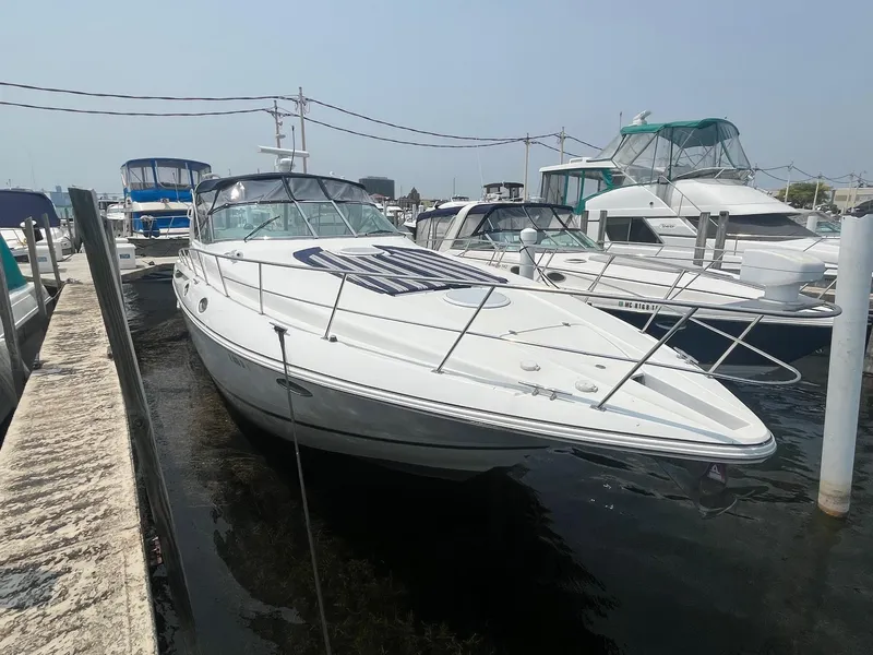 Slide: The Image of 2001 Cruisers Yachts 3870 Express docked at a marina, surrounded by other boats. - 4