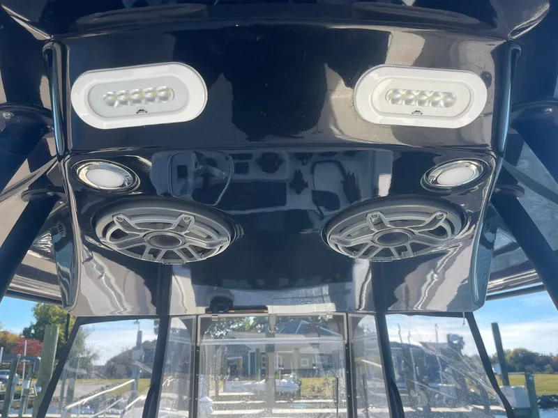 Slide: The Image of 2023 Cobia 320 CC boat speakers and LED lights on black console. - 15