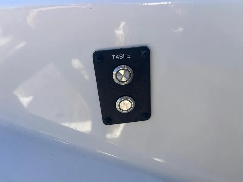 Slide: The Image of Cobia 320 CC 2023 boat table control panel with buttons. - 25