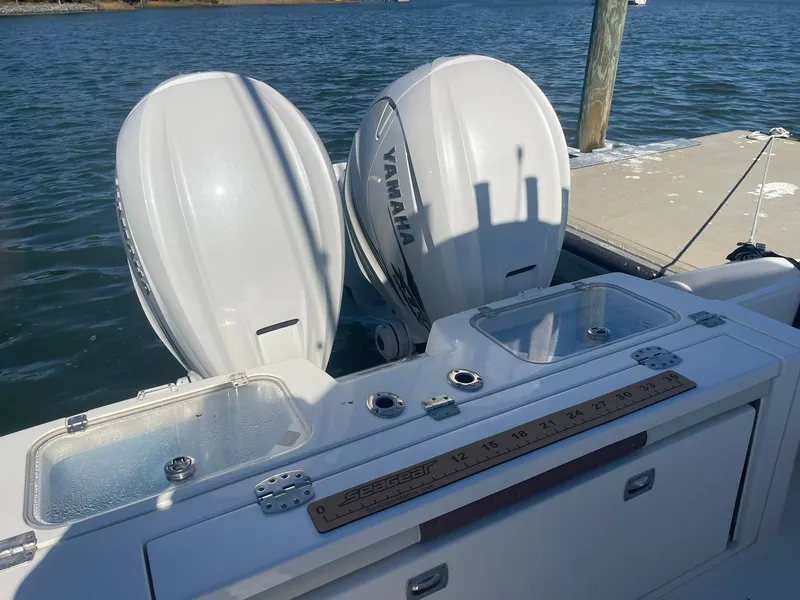 Slide: The Image of 2023 Cobia 320 CC boat with dual Yamaha outboard engines at dock. - 5