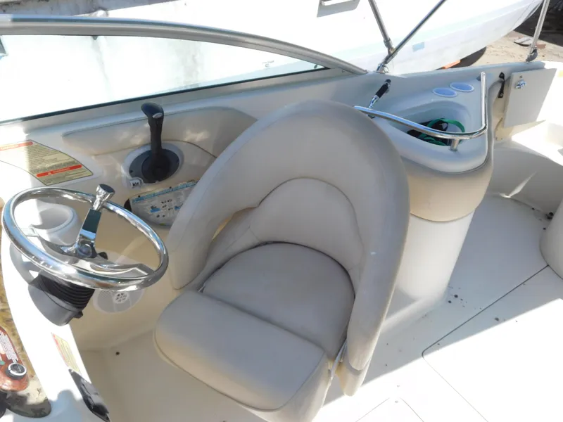 Slide: The Image of 2002 Sea Ray 240 Sundeck helm with steering wheel and control panel. - 10