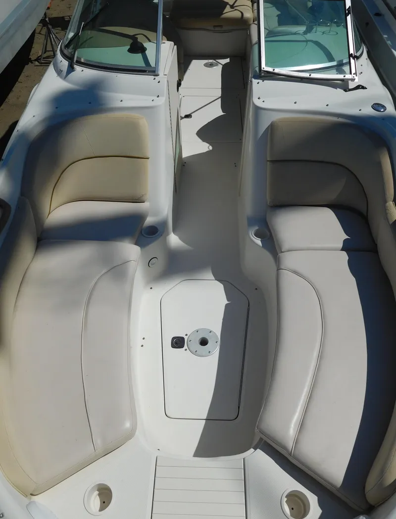 Slide: The Image of 2002 Sea Ray 240 Sundeck interior with spacious seating and open deck layout. - 14