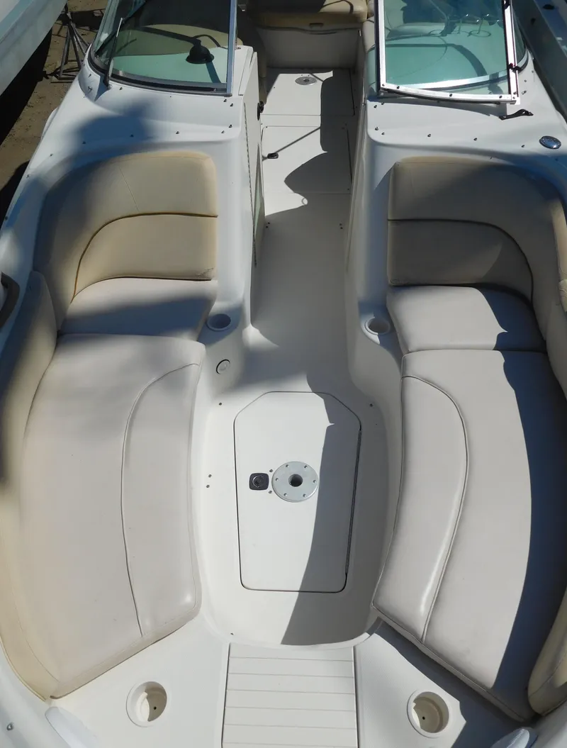 Slide: The Image of 2002 Sea Ray 240 Sundeck boat interior with spacious seating and open deck layout. - 15