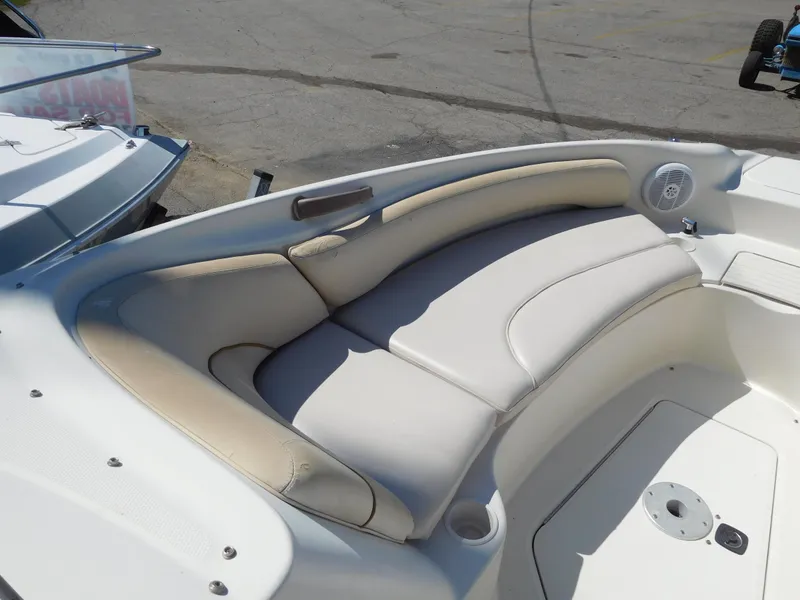 Slide: The Image of 2002 Sea Ray 240 Sundeck boat interior with cushioned seating. - 16