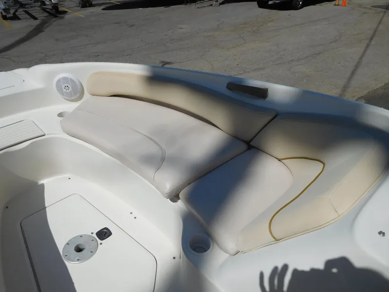 Slide: The Image of 2002 Sea Ray 240 Sundeck boat interior seating area in sunlight. - 17