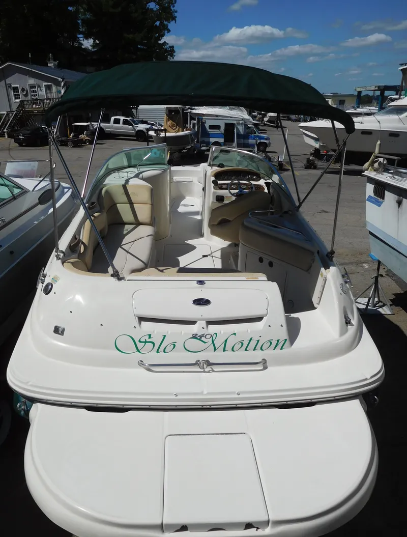 Slide: The Image of 2002 Sea Ray 240 Sundeck boat with canopy, docked in marina. - 3
