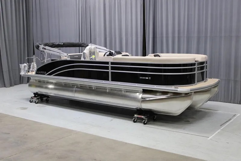 Slide: The Image of 2025 Harris CRUISER 230 SL pontoon boat in showroom setting. - 1