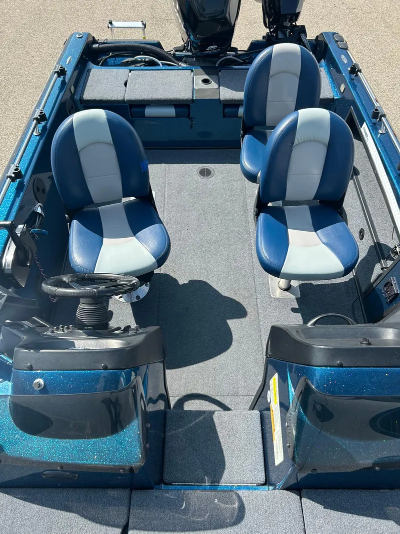 Slide: The Image of 2005 Skeeter WX 1880 boat interior with blue and gray seating. - 17
