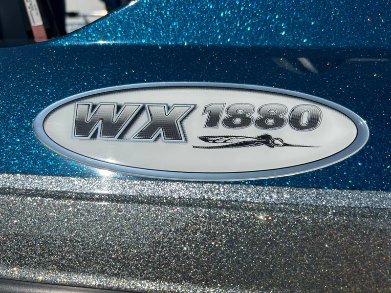 Slide: The Image of 2005 Skeeter WX 1880 boat logo on a glittery blue surface. - 26