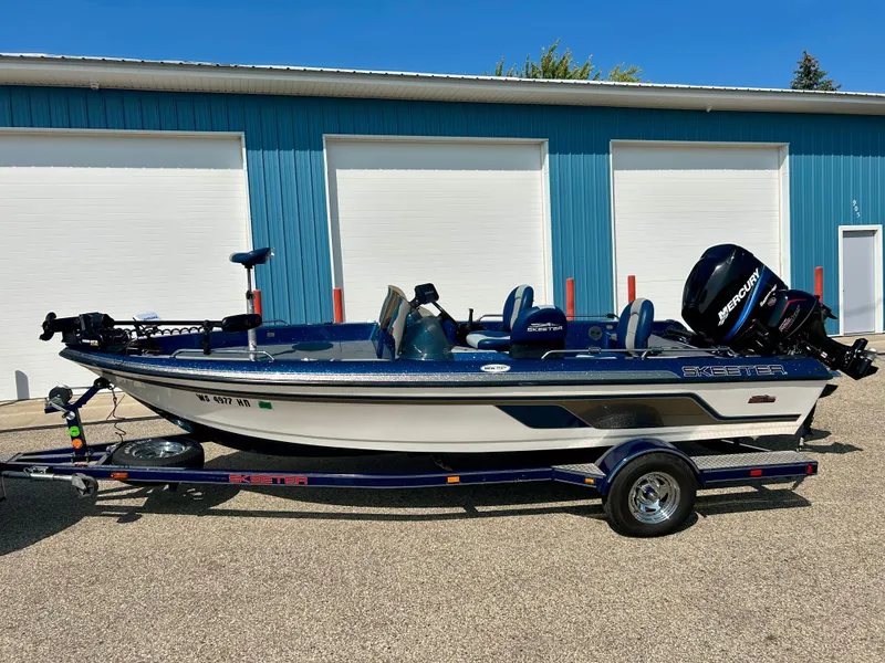 Slide: The Image of 2005 Skeeter WX 1880 boat with trailer, parked in front of blue garage doors. - 29