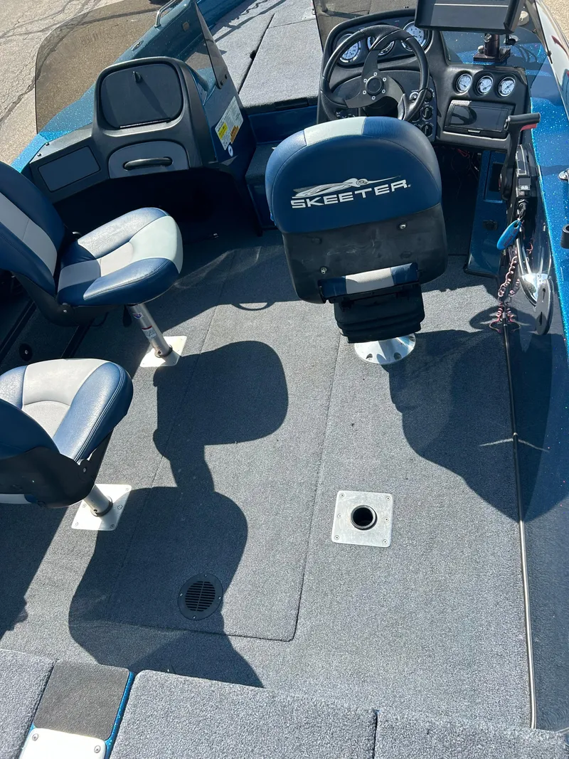 Slide: The Image of 2005 Skeeter WX 1880 boat interior with steering console and seating. - 33