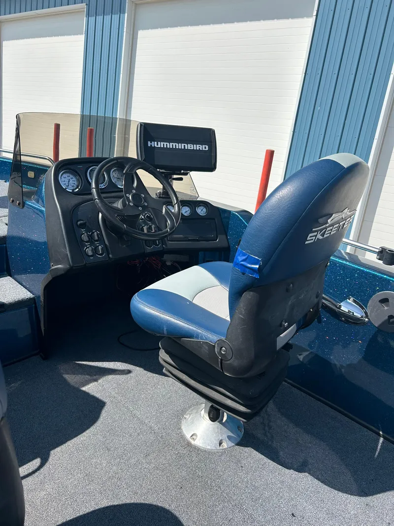 Slide: The Image of 2005 Skeeter WX 1880 boat interior with steering wheel and Humminbird display. - 34