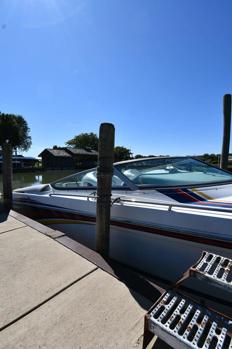 Slide: The Image of 2003 Formula 353 FASTech boat docked under clear blue sky. - 1
