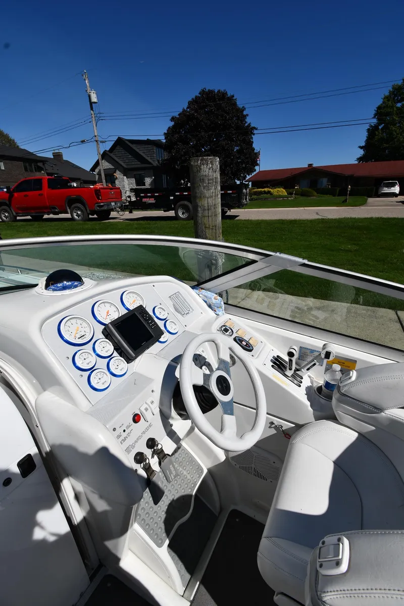 Slide: The Image of 2003 Formula 353 FASTech boat cockpit with white interior and modern dashboard controls. - 10