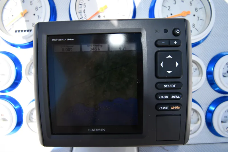 Slide: The Image of Garmin GPS device on 2003 Formula 353 FASTech dashboard with gauges in background. - 13