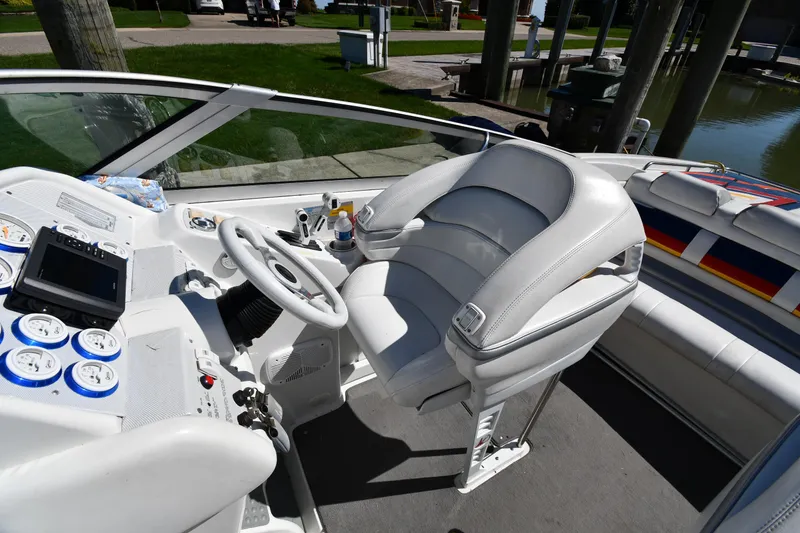 Slide: The Image of 2003 Formula 353 FASTech boat cockpit with white leather seating and modern controls. - 15