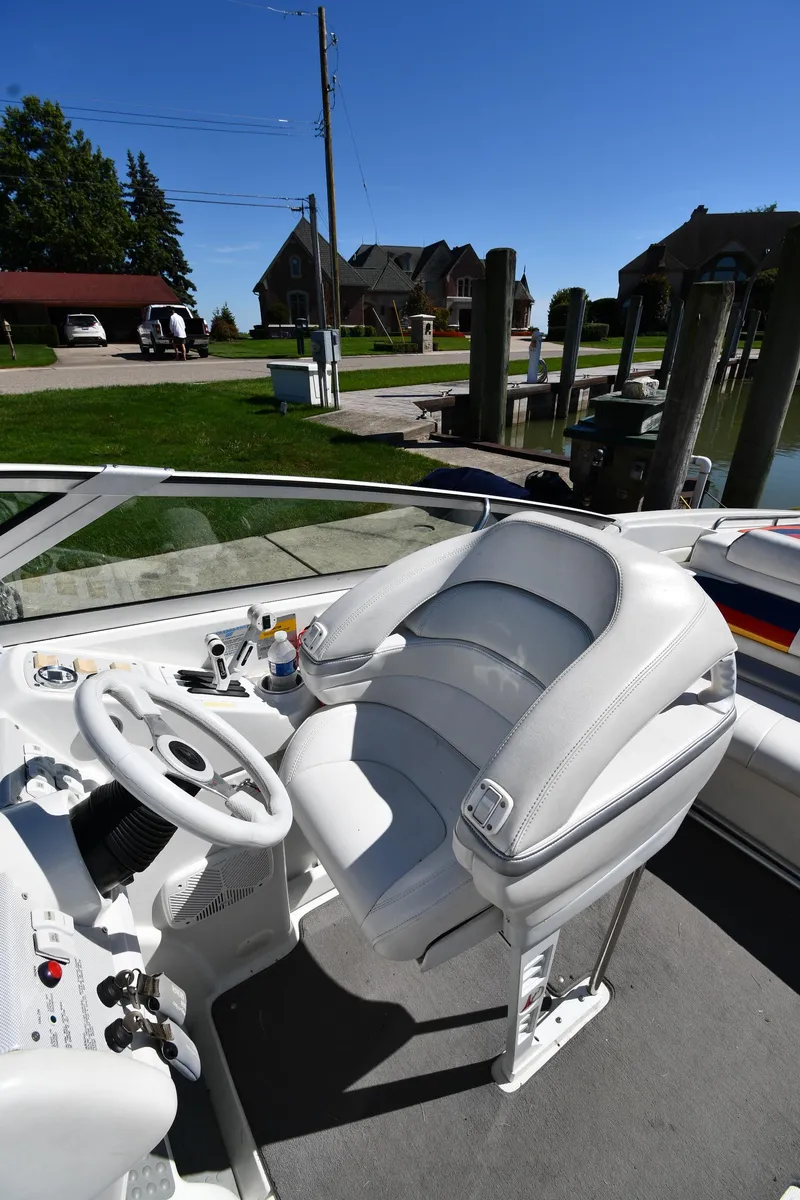 Slide: The Image of 2003 Formula 353 FASTech boat cockpit with white leather seating and steering wheel. - 16