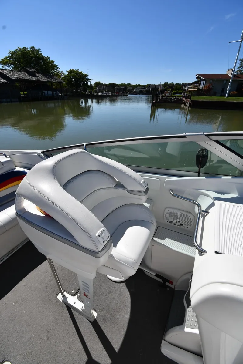 Slide: The Image of 2003 Formula 353 FASTech boat interior with white seating, docked by calm waters. - 18