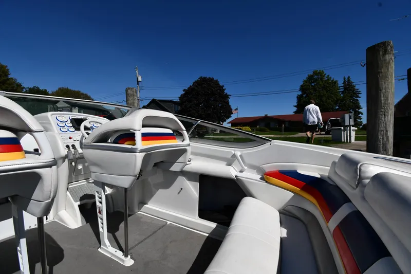 Slide: The Image of 2003 Formula 353 FASTech boat interior with colorful seating and control panel. - 19