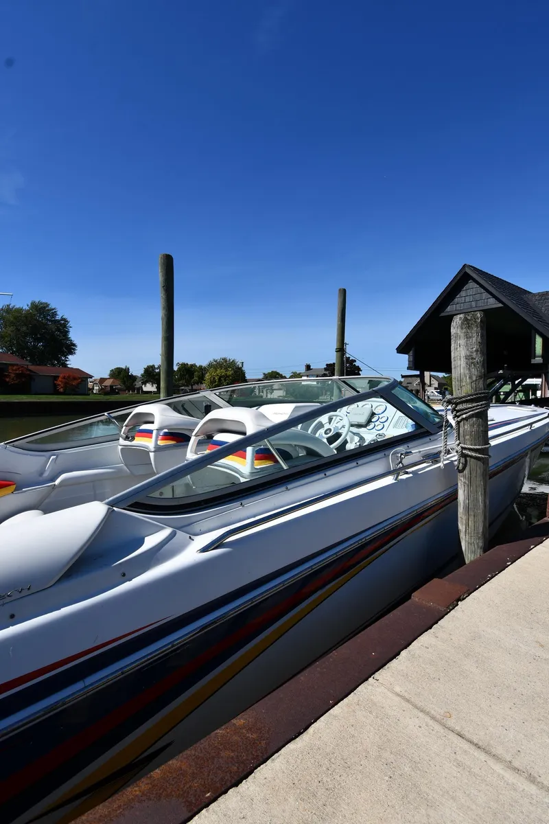 Slide: The Image of 2003 Formula 353 FASTech speedboat docked under clear blue sky. - 2