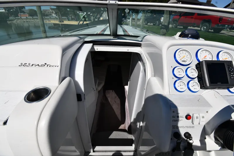 Slide: The Image of 2003 Formula 353 FASTech boat cockpit with gauges and open cabin door. - 25